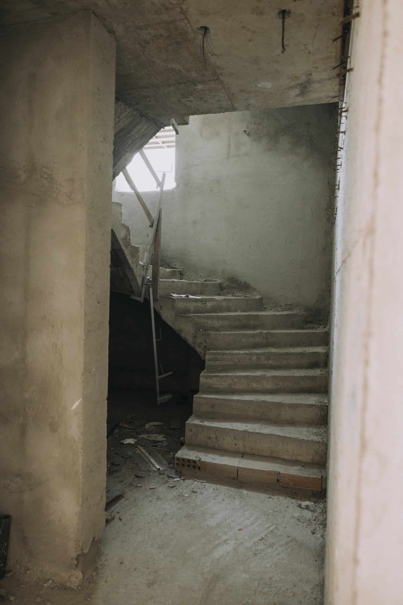 Kabu Residences staircase during construction, with unfinished concrete and plaster.
