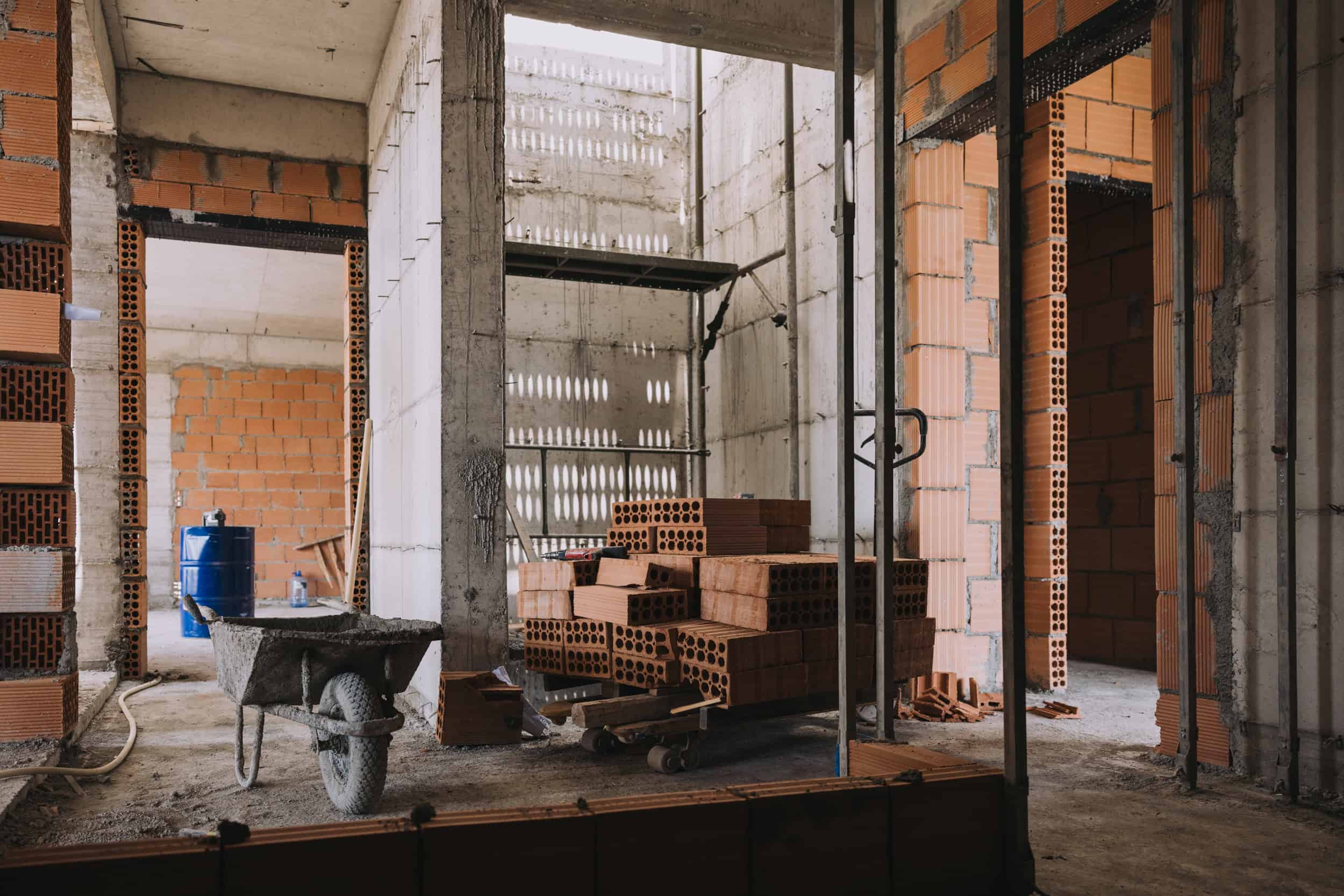 Sora Residences during construction, with brickwork and building materials.