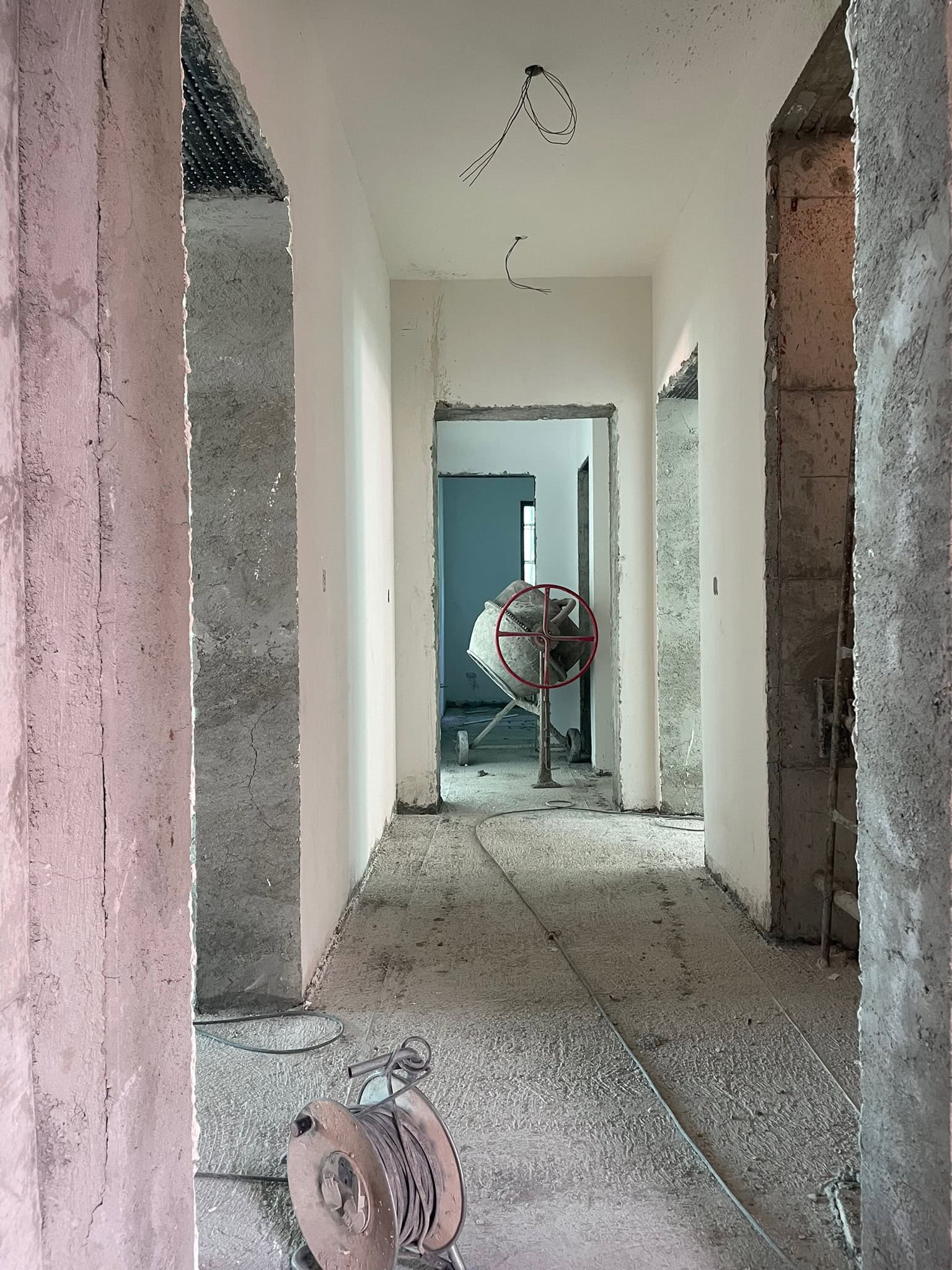 Azor Residences during construction, showing unfinished rooms and building equipment.